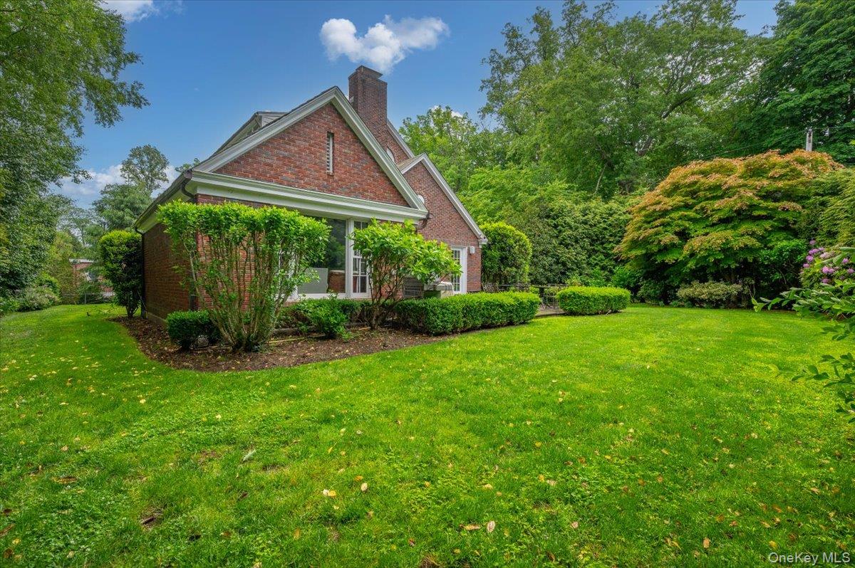 7 Harcourt Road Scarsdale, NY 10583 - Photo 27 of 34 a view of a house with backyard and garden
