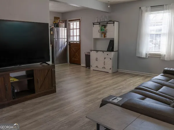 a living room with furniture and a wooden floor