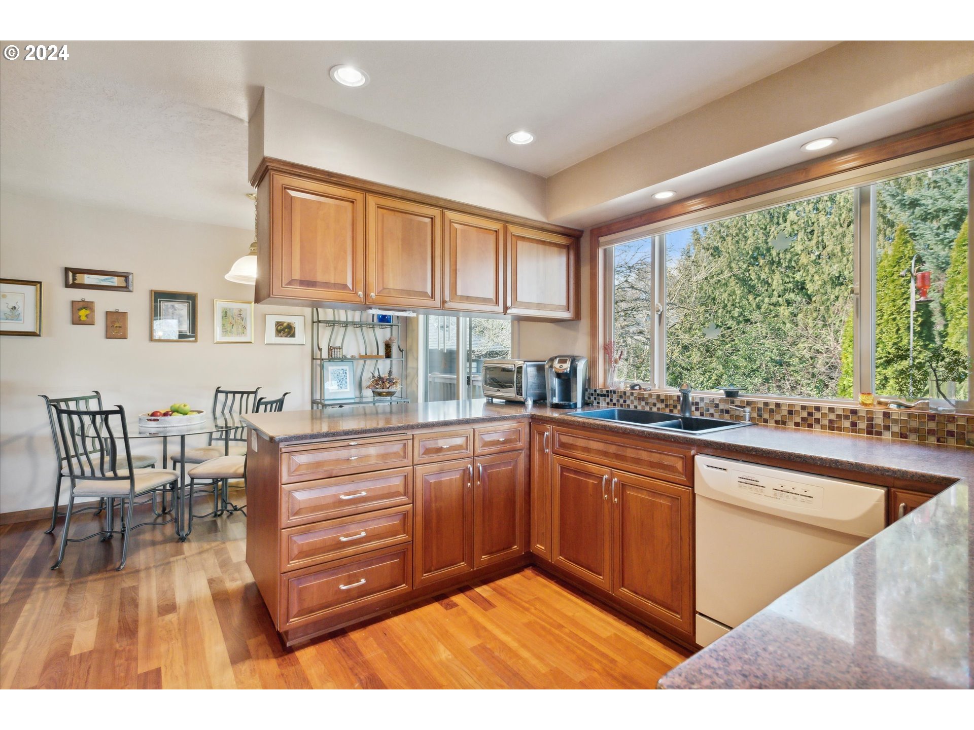 8027 Southwest Ruby Terrace Portland, OR 97219 - Photo 8 of 30 a kitchen with stainless steel appliances granite countertop a stove a sink and a microwave