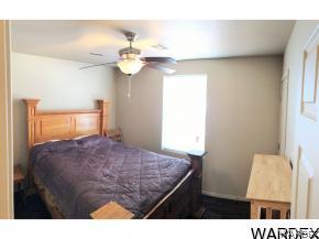 737 Heber Road Golden Valley, AZ 86413 - Photo 11 of 26 a bedroom with a bed and a chandelier