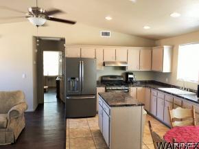 737 Heber Road Golden Valley, AZ 86413 - Photo 6 of 26 a kitchen with stainless steel appliances granite countertop a refrigerator a sink and a stove