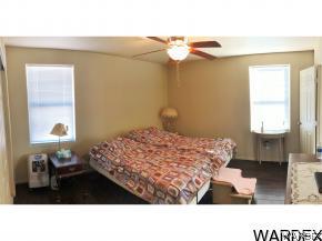 737 Heber Road Golden Valley, AZ 86413 - Photo 7 of 26 a bedroom with a bed and a chandelier