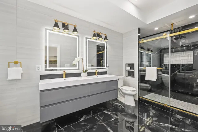 a bathroom with a double vanity sink a mirror and a shower