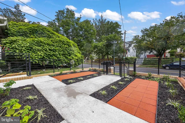 a view of a backyard with swimming pool and sitting area