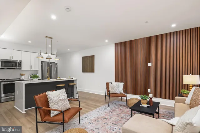 a living room with furniture and a kitchen view