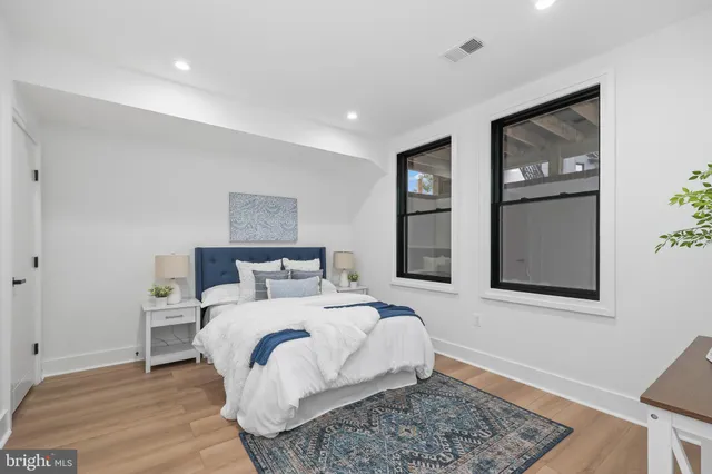 a bedroom with a large bed and a window