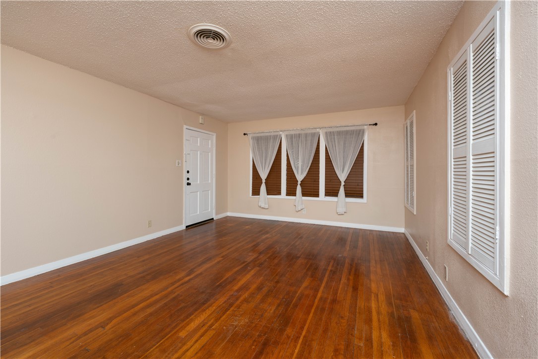 622 Deforrest Street Corpus Christi, TX 78404 - Photo 2 of 14 a view of an empty room with wooden floor and a window