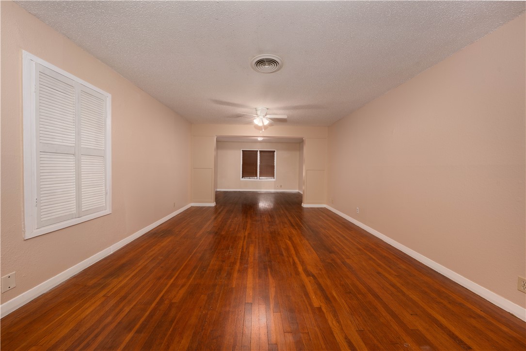 622 Deforrest Street Corpus Christi, TX 78404 - Photo 3 of 14 a view of empty room with wooden floor and fan