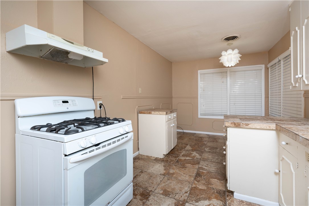 622 Deforrest Street Corpus Christi, TX 78404 - Photo 6 of 14 a kitchen with a stove a sink and a refrigerator