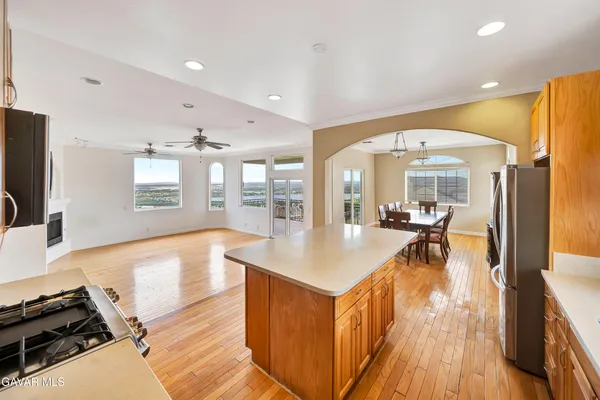an empty room with windows and fireplace