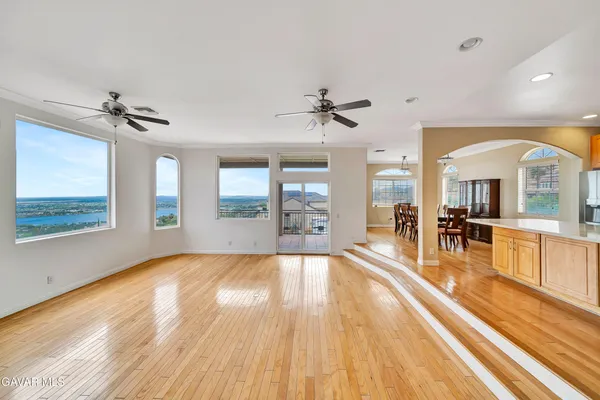 a living room with stainless steel appliances kitchen island granite countertop furniture and a kitchen view