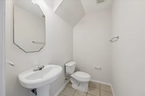 a bathroom with a sink a toilet and mirror