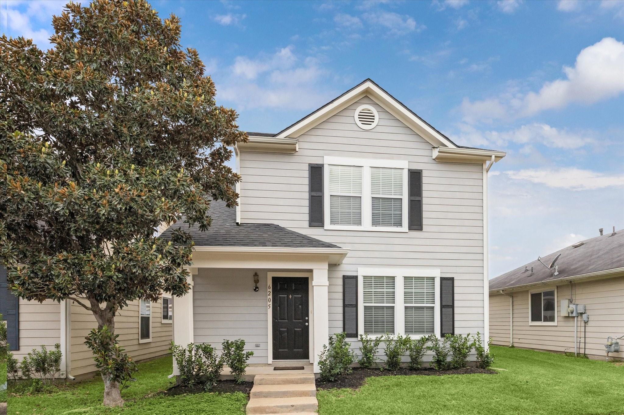 6205 Lone Prairie Way Katy, TX 77449 - Photo 2 of 21 a front view of a house with garden