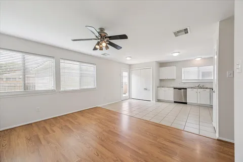 a view of a kitchen with an empty space and wooden floor