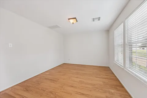 a view of a room with wooden floor and window