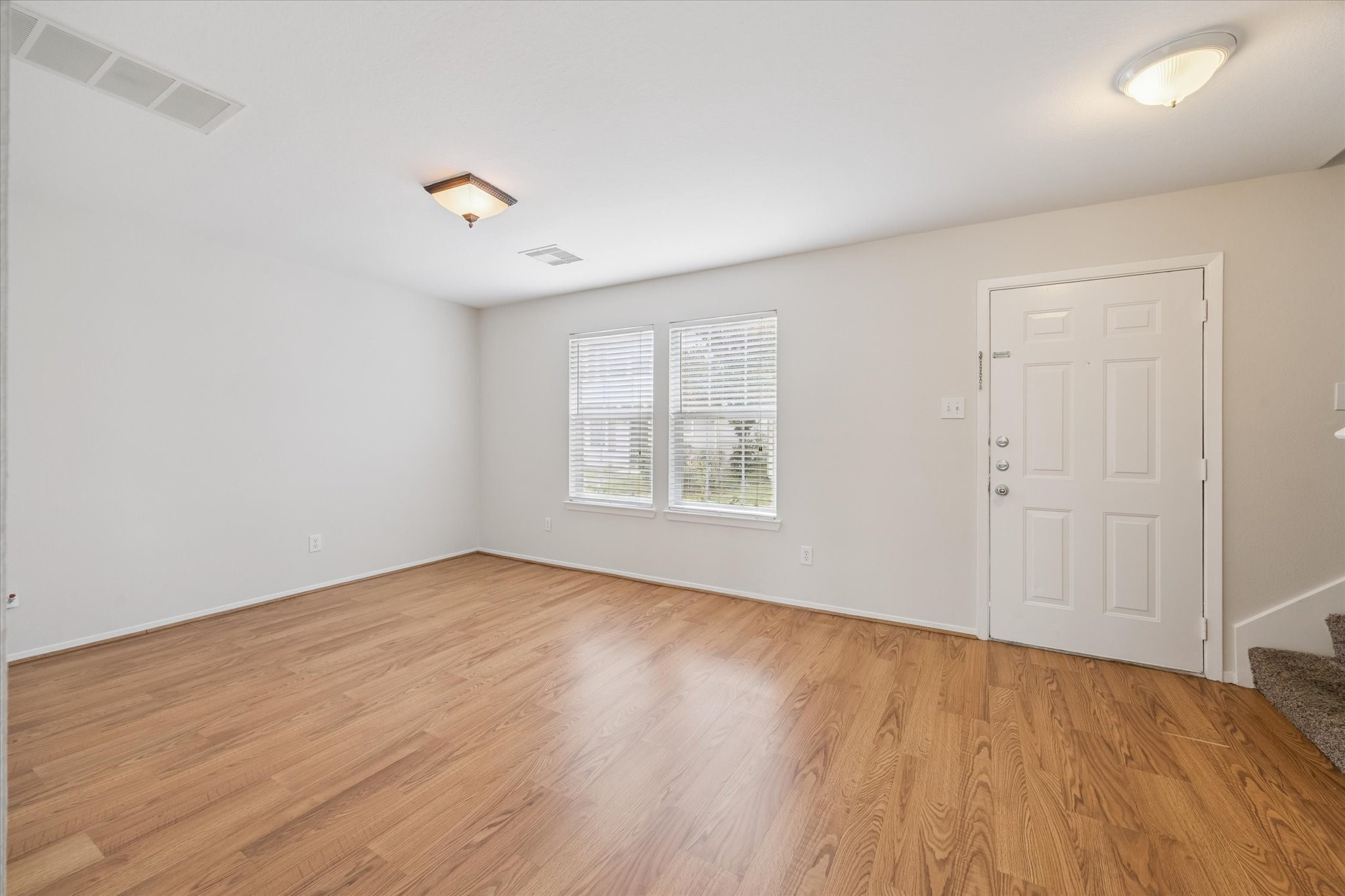 6205 Lone Prairie Way Katy, TX 77449 - Photo 8 of 21 wooden floor in an empty room with a window