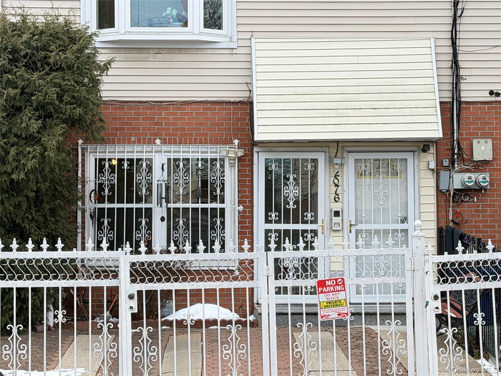 2076 Caesar Place Bronx, NY 10473 - Photo 3 of 8 a front view of a house with a porch