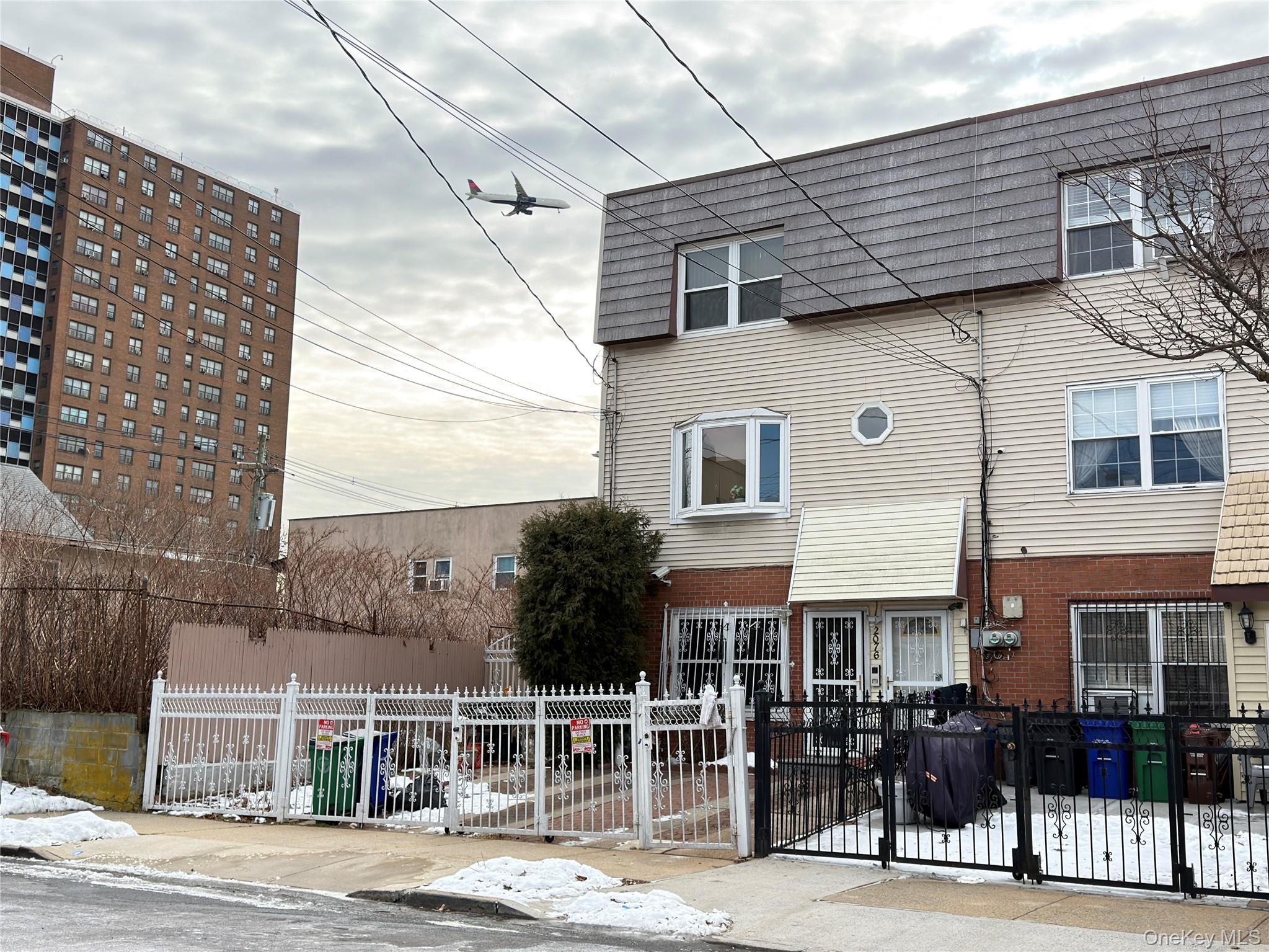 2076 Caesar Place Bronx, NY 10473 - Photo 5 of 8 a front view of a building with street