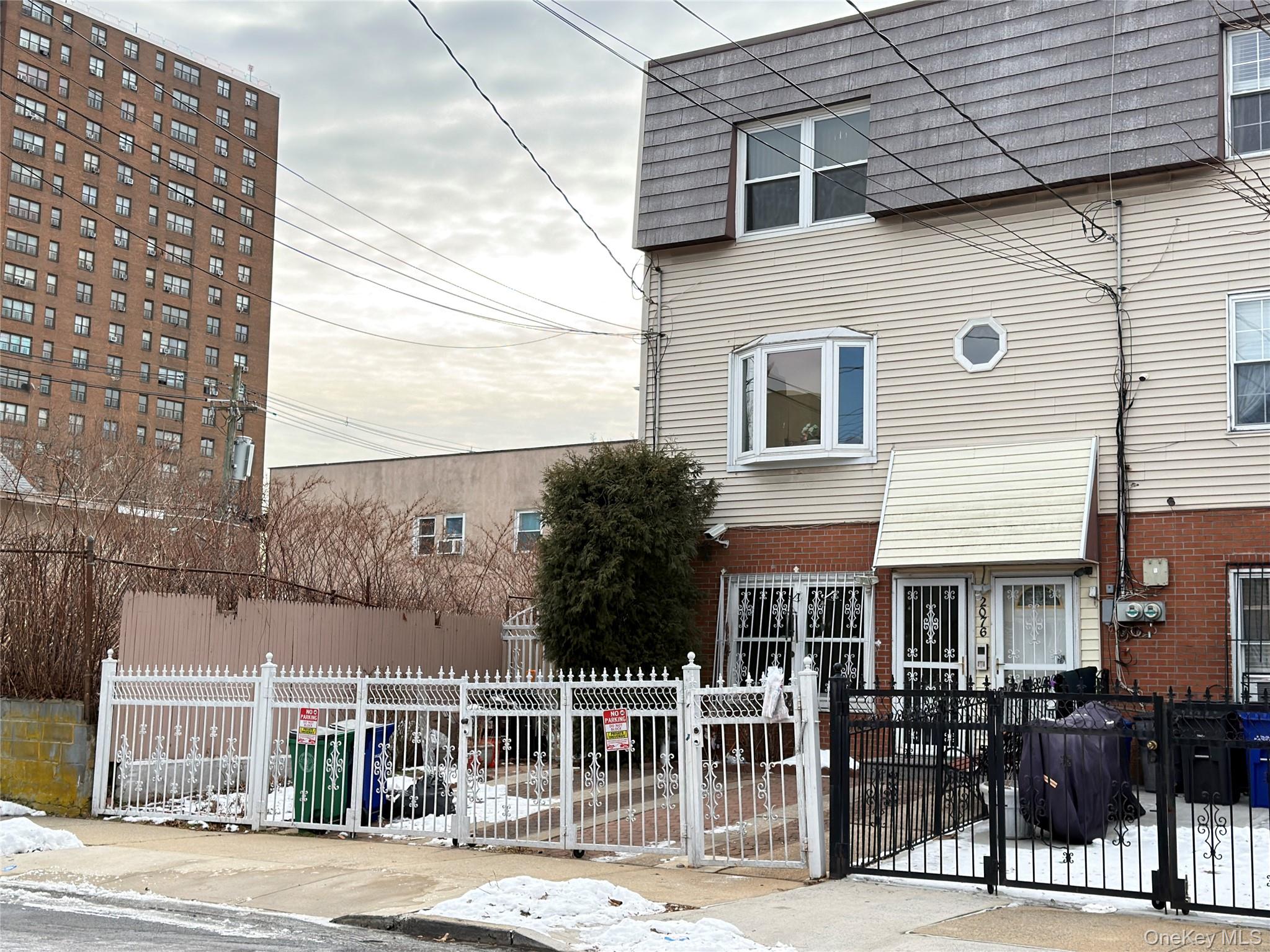 2076 Caesar Place Bronx, NY 10473 - Photo 7 of 8 a front view of a house with a garden