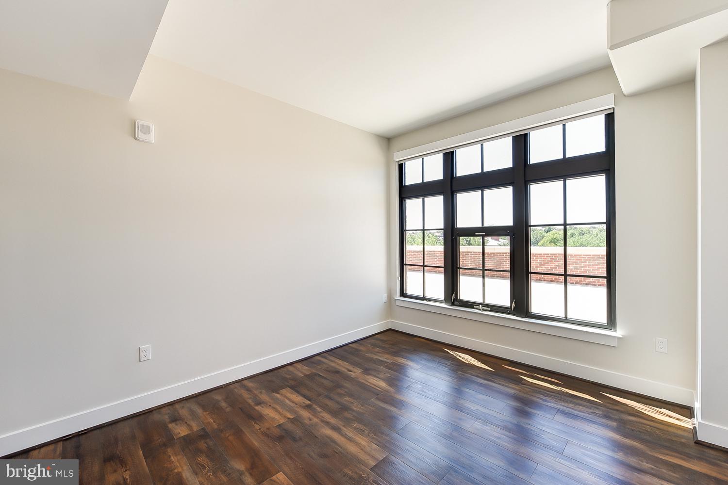 901 H Street Northeast, Unit AT D Washington, DC 20002 - Photo 15 of 82 wooden floor in an empty room with a window