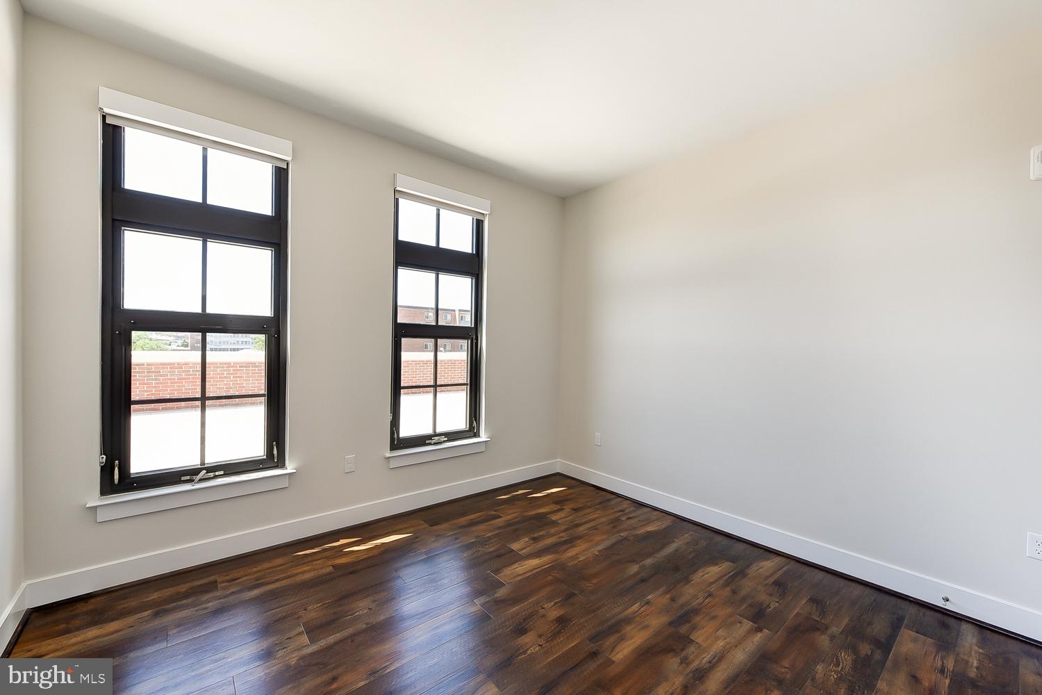 901 H Street Northeast, Unit AT D Washington, DC 20002 - Photo 17 of 82 an empty room with wooden floor and windows