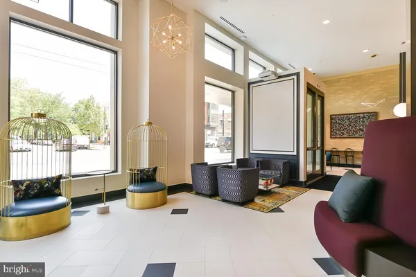 a living room with furniture potted plant and a large window