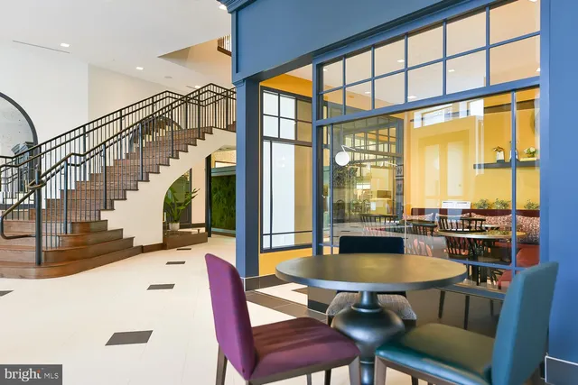 a kitchen with a table chairs stove and kitchen view