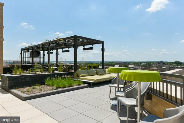 a view of a backyard with a garden and entertaining space