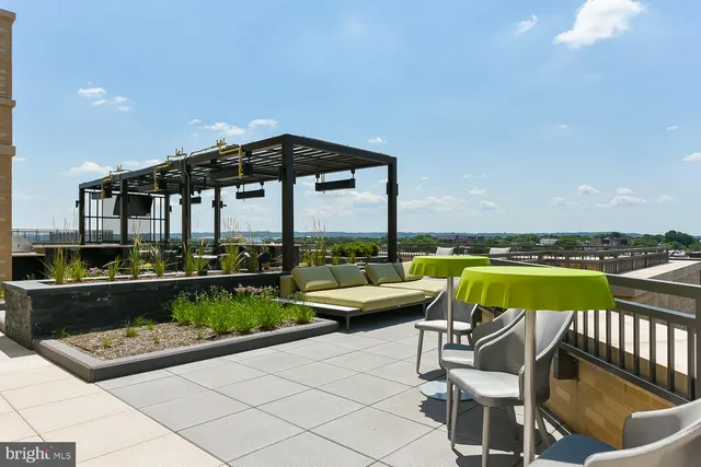 a view of a backyard with a garden and entertaining space