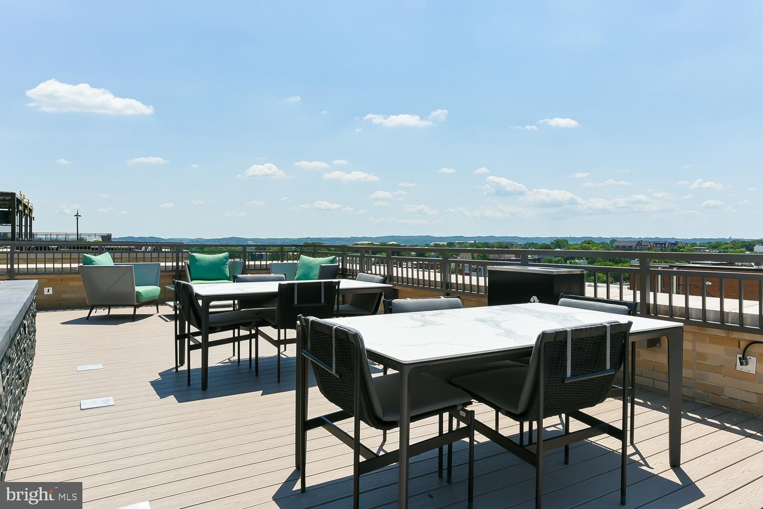 901 H Street Northeast, Unit AT D Washington, DC 20002 - Photo 43 of 82 a view of a roof deck with table and chairs