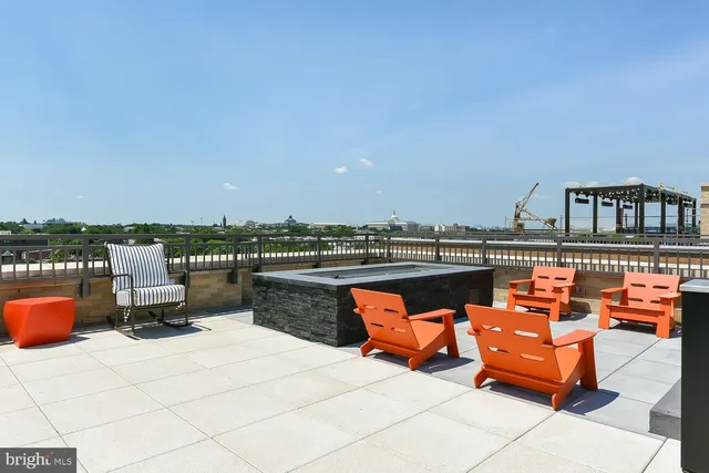 a dining room with furniture and a floor to ceiling window