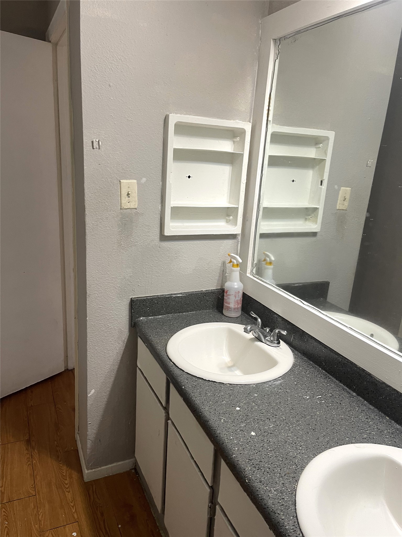 1902 West Loop, Unit B1 Austin, TX 78758 - Photo 14 of 23 Double vanity with integrated sinks and a speckled countertop