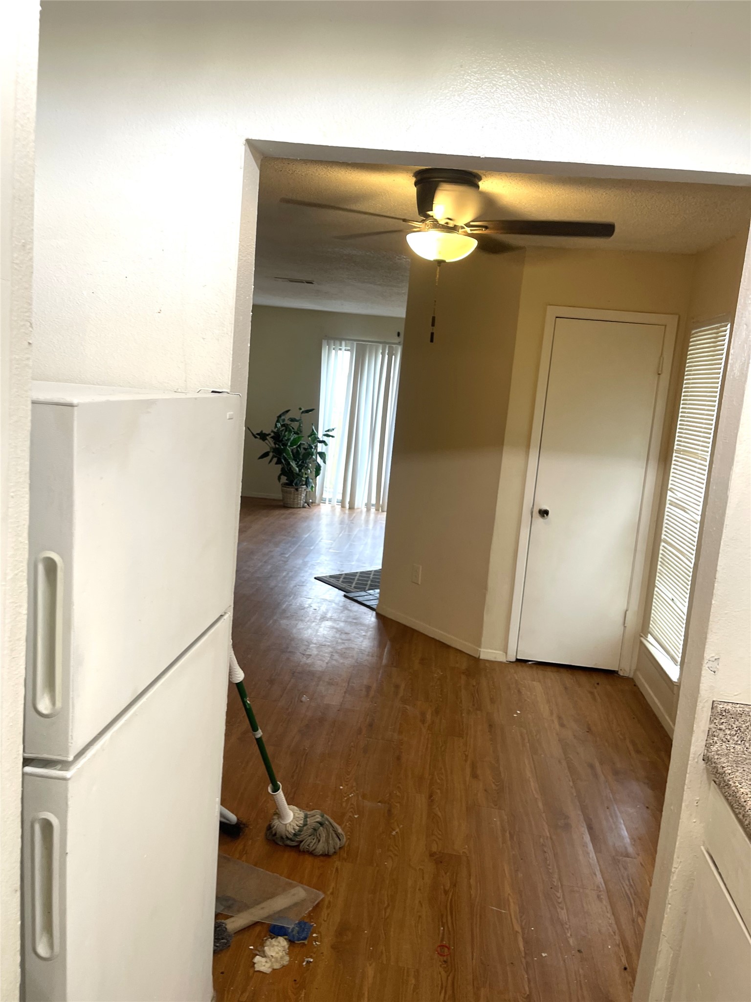 1902 West Loop, Unit B1 Austin, TX 78758 - Photo 19 of 23 Interior space featuring wood-finish flooring, a ceiling fan with integrated lighting, and a white interior door