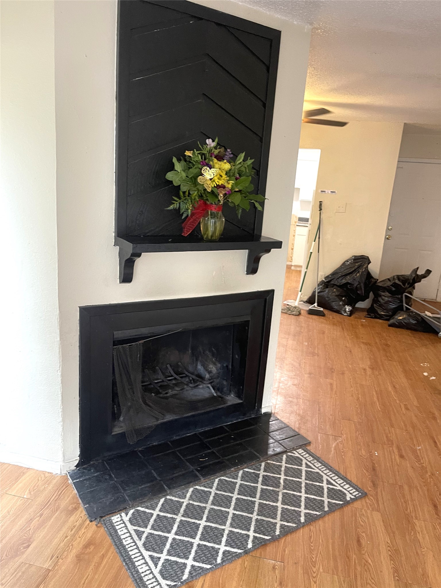 1902 West Loop, Unit B1 Austin, TX 78758 - Photo 20 of 23 Fireplace featuring a black herringbone panel, mantel shelf, and black tile hearth