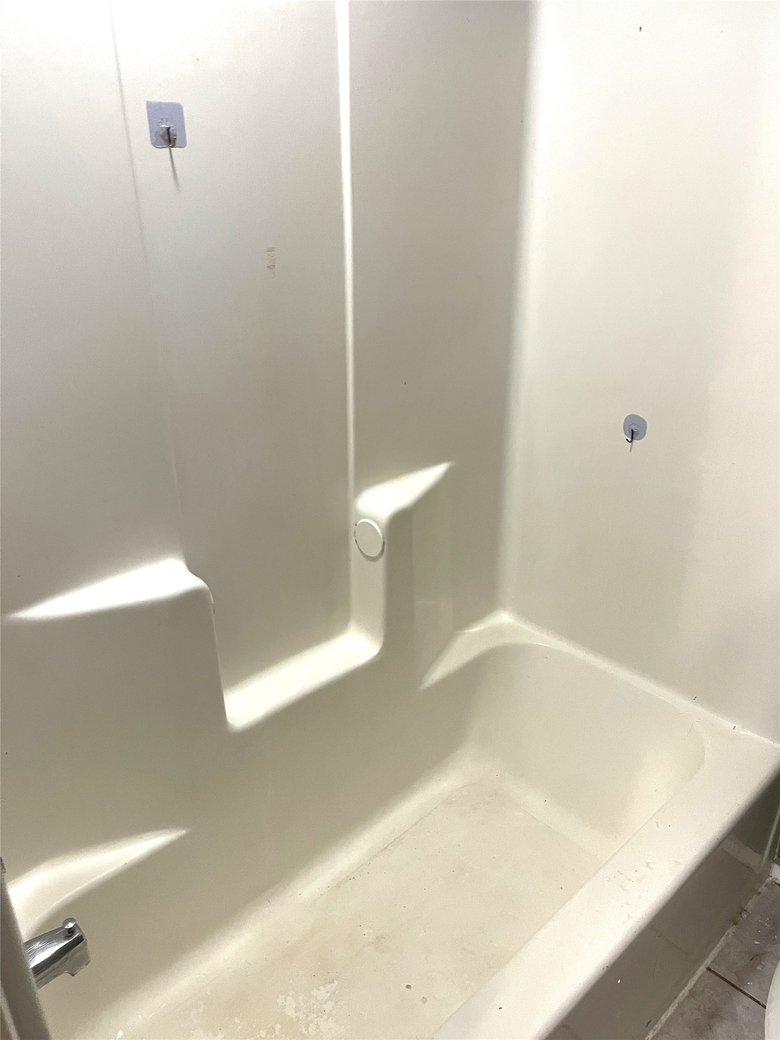 1902 West Loop, Unit B1 Austin, TX 78758 - Photo 10 of 23 Fiberglass tub and shower surround with integrated soap ledges and a chrome tub filler