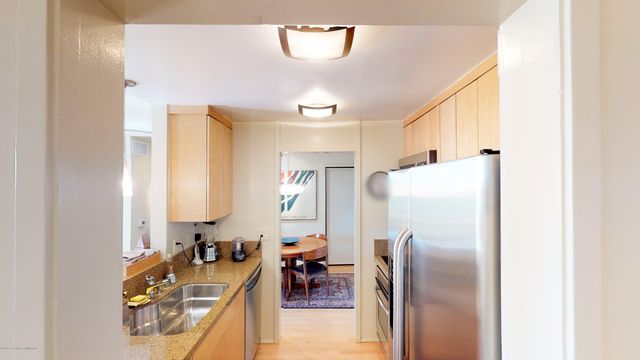 a kitchen with a refrigerator and a sink