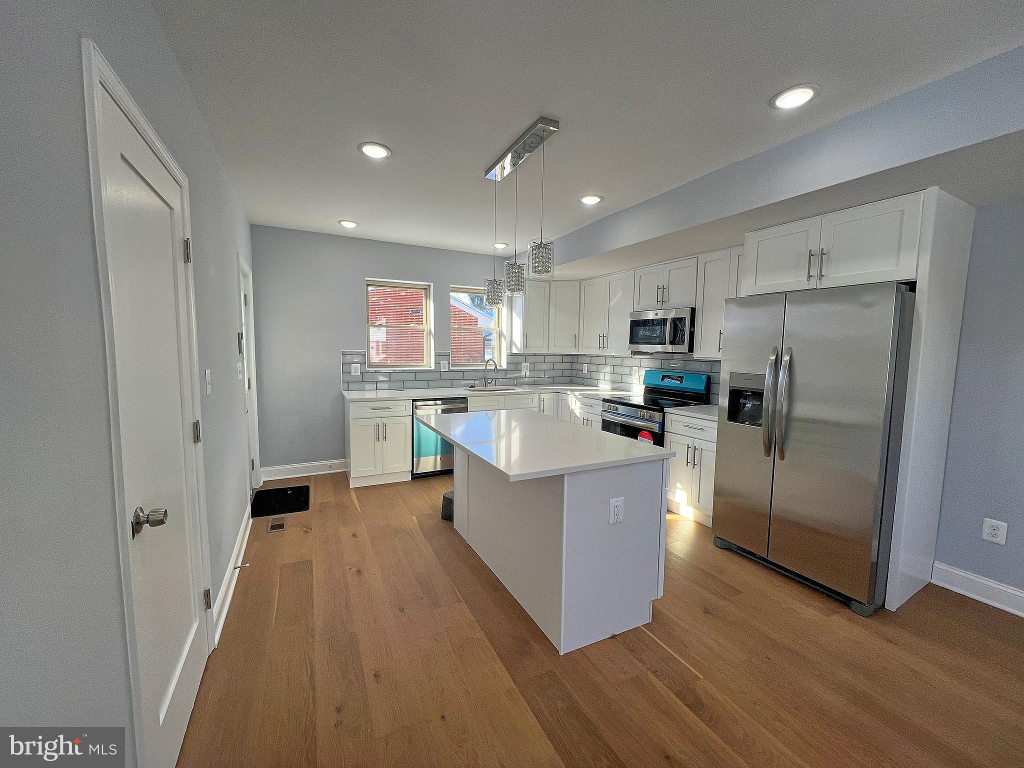 4311 Miami Place Baltimore, MD 21207 - Photo 11 of 26 a kitchen with stainless steel appliances a refrigerator a sink dishwasher stove and wooden cabinets