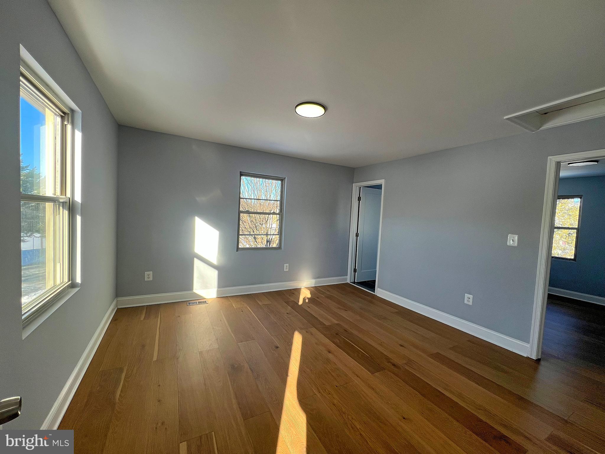 4311 Miami Place Baltimore, MD 21207 - Photo 12 of 26 a view of an empty room with wooden floor and a window