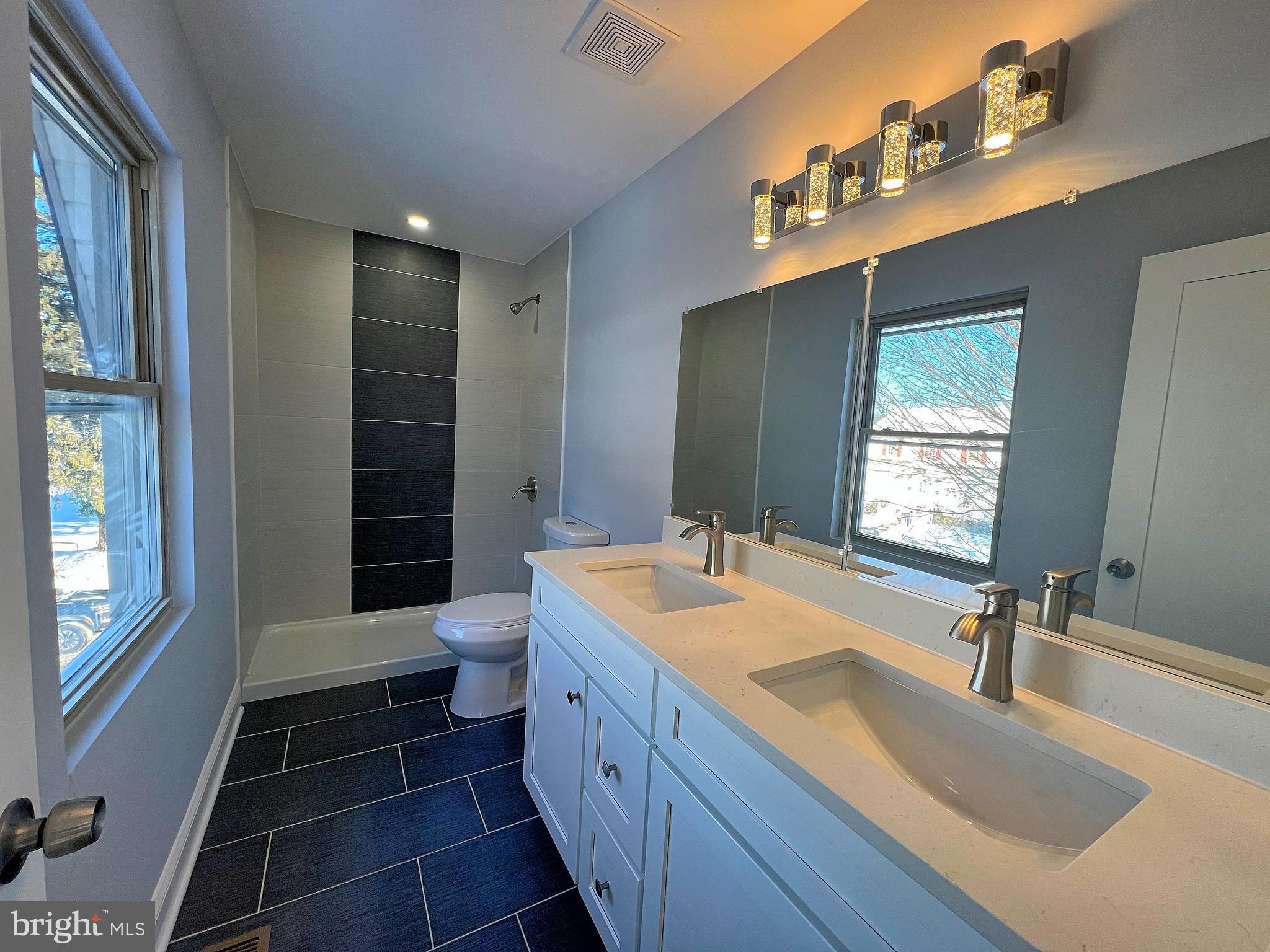 4311 Miami Place Baltimore, MD 21207 - Photo 13 of 26 a bathroom with a sink double vanity and a shower