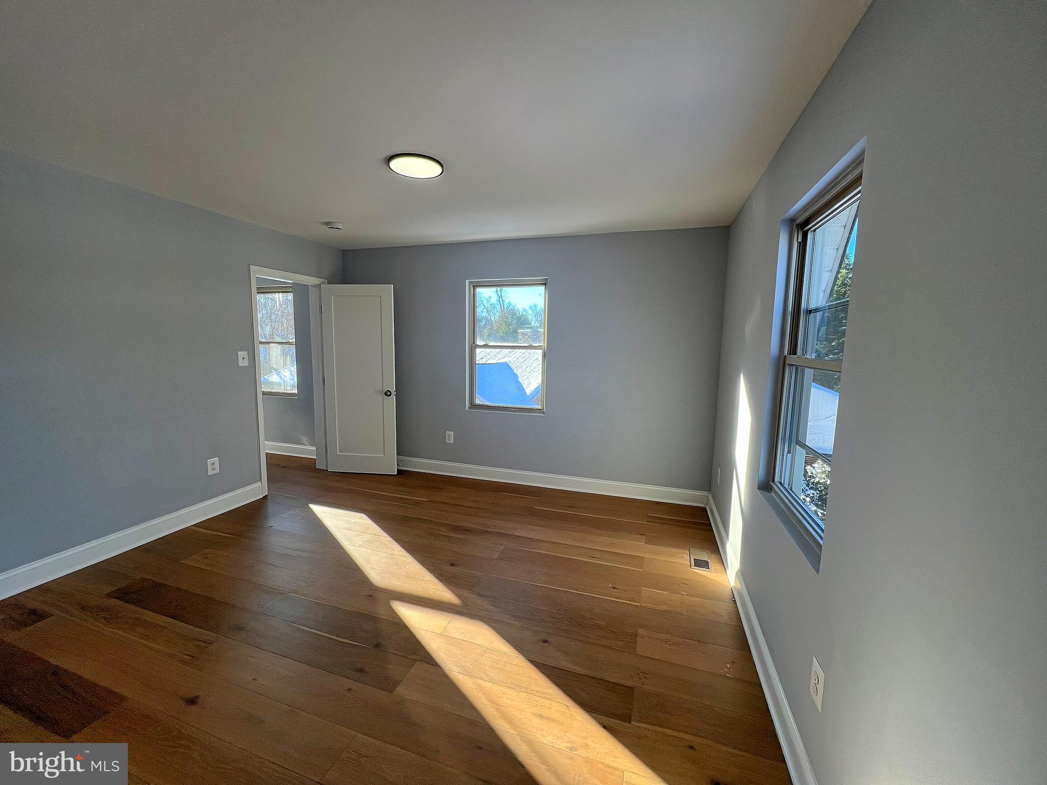 4311 Miami Place Baltimore, MD 21207 - Photo 15 of 26 wooden floor in an empty room with a window
