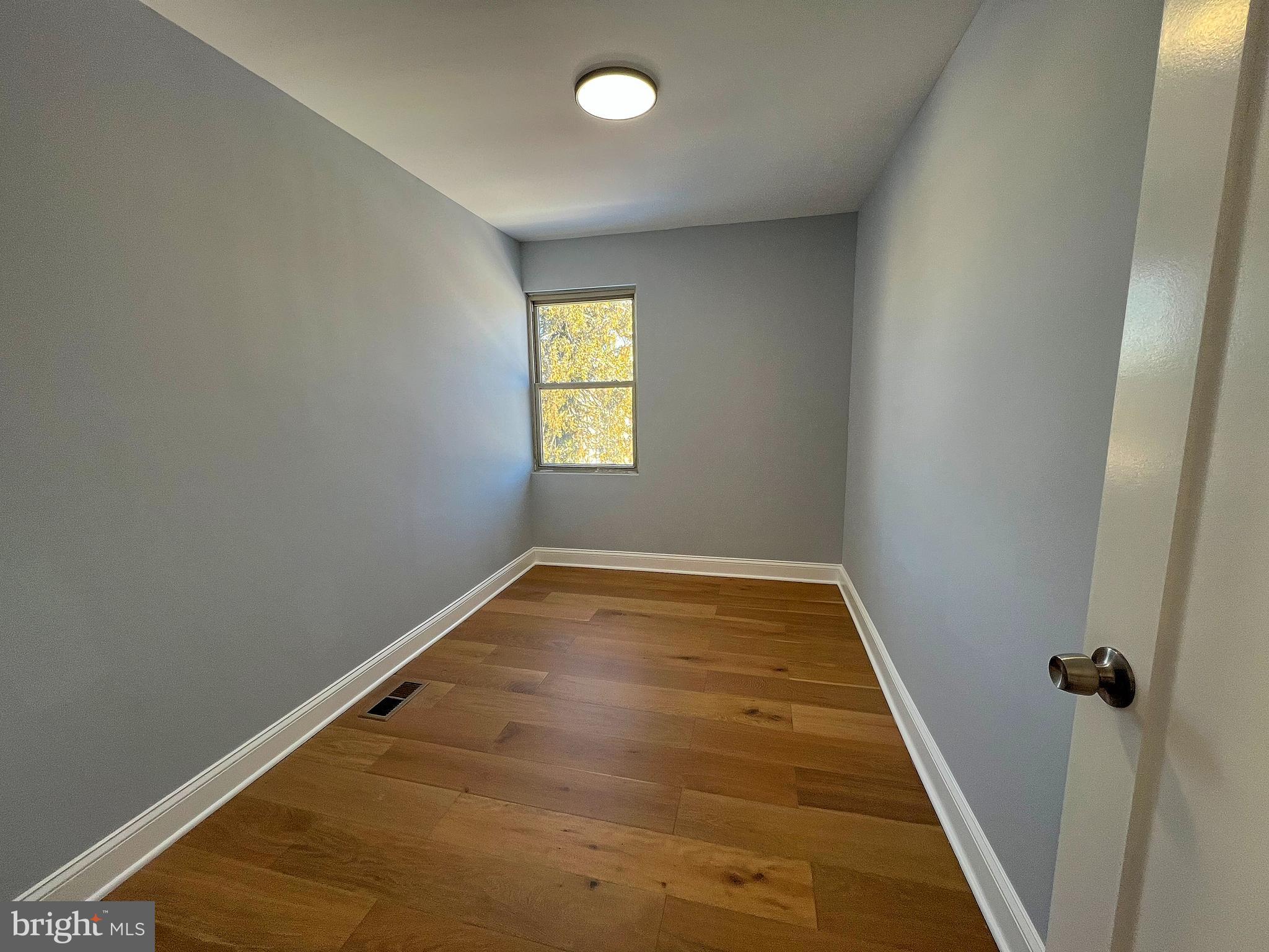4311 Miami Place Baltimore, MD 21207 - Photo 16 of 26 wooden floor in an empty room with a window