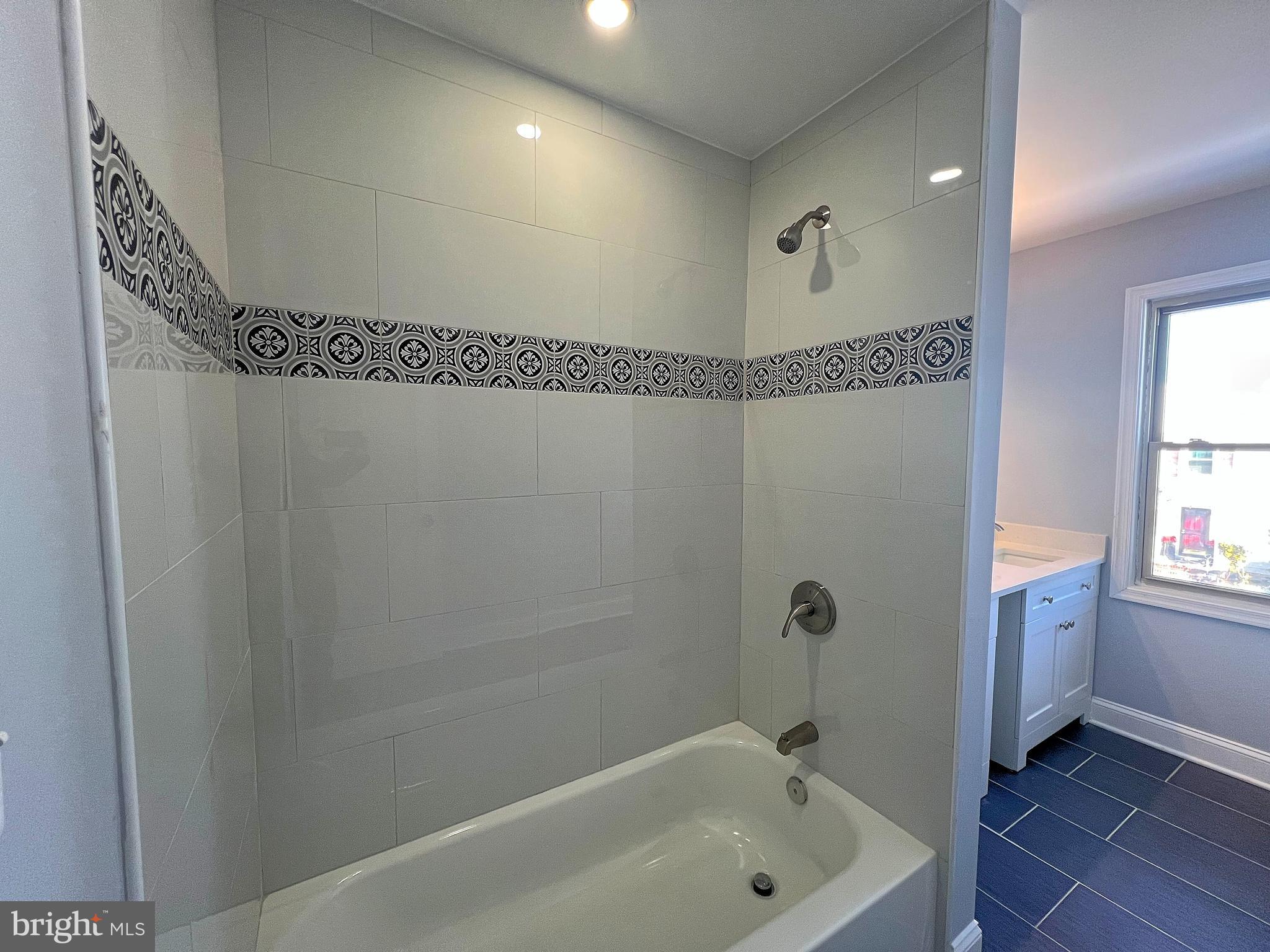 4311 Miami Place Baltimore, MD 21207 - Photo 19 of 26 a bathroom with a tub a sink and a window
