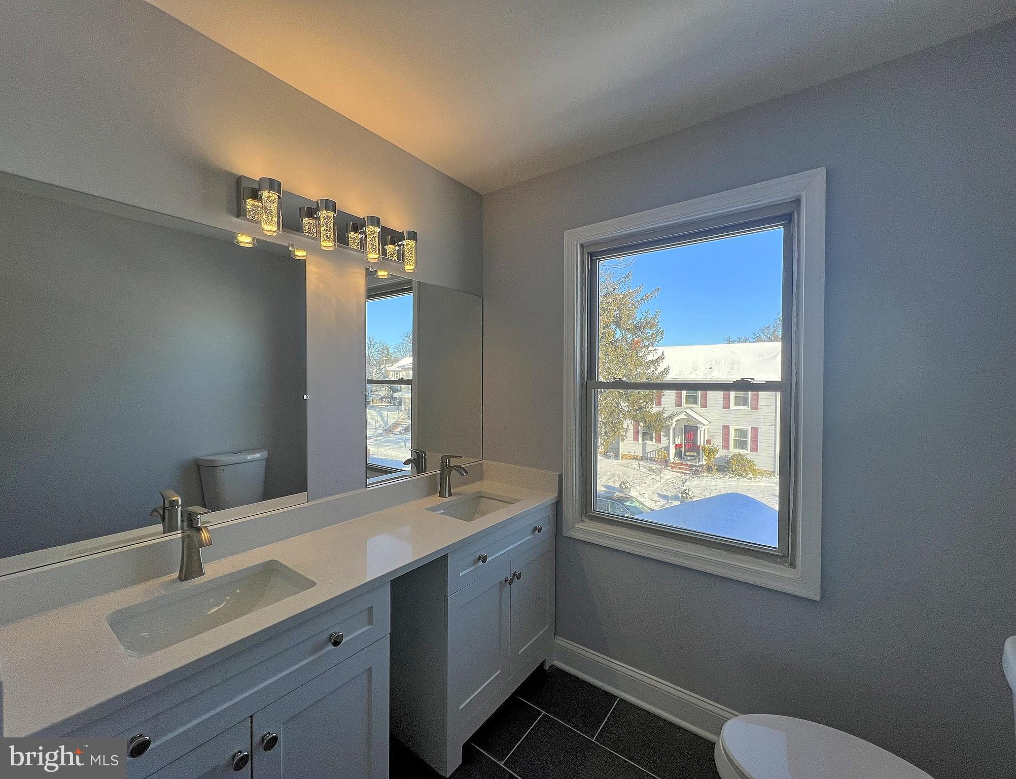 4311 Miami Place Baltimore, MD 21207 - Photo 20 of 26 a bathroom with 2 sink tub and a mirror