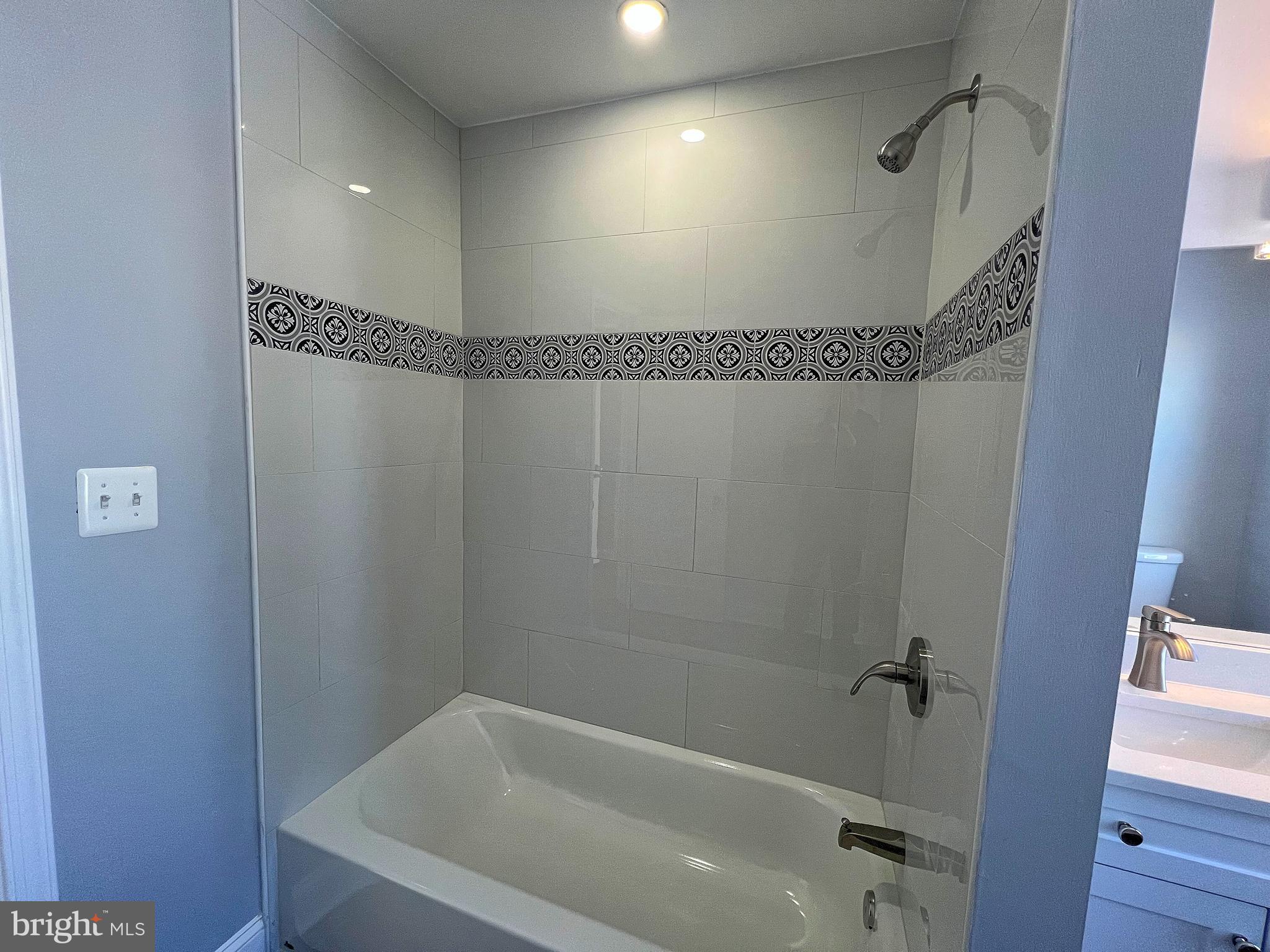 4311 Miami Place Baltimore, MD 21207 - Photo 21 of 26 a bathroom with a bathtub and a shower