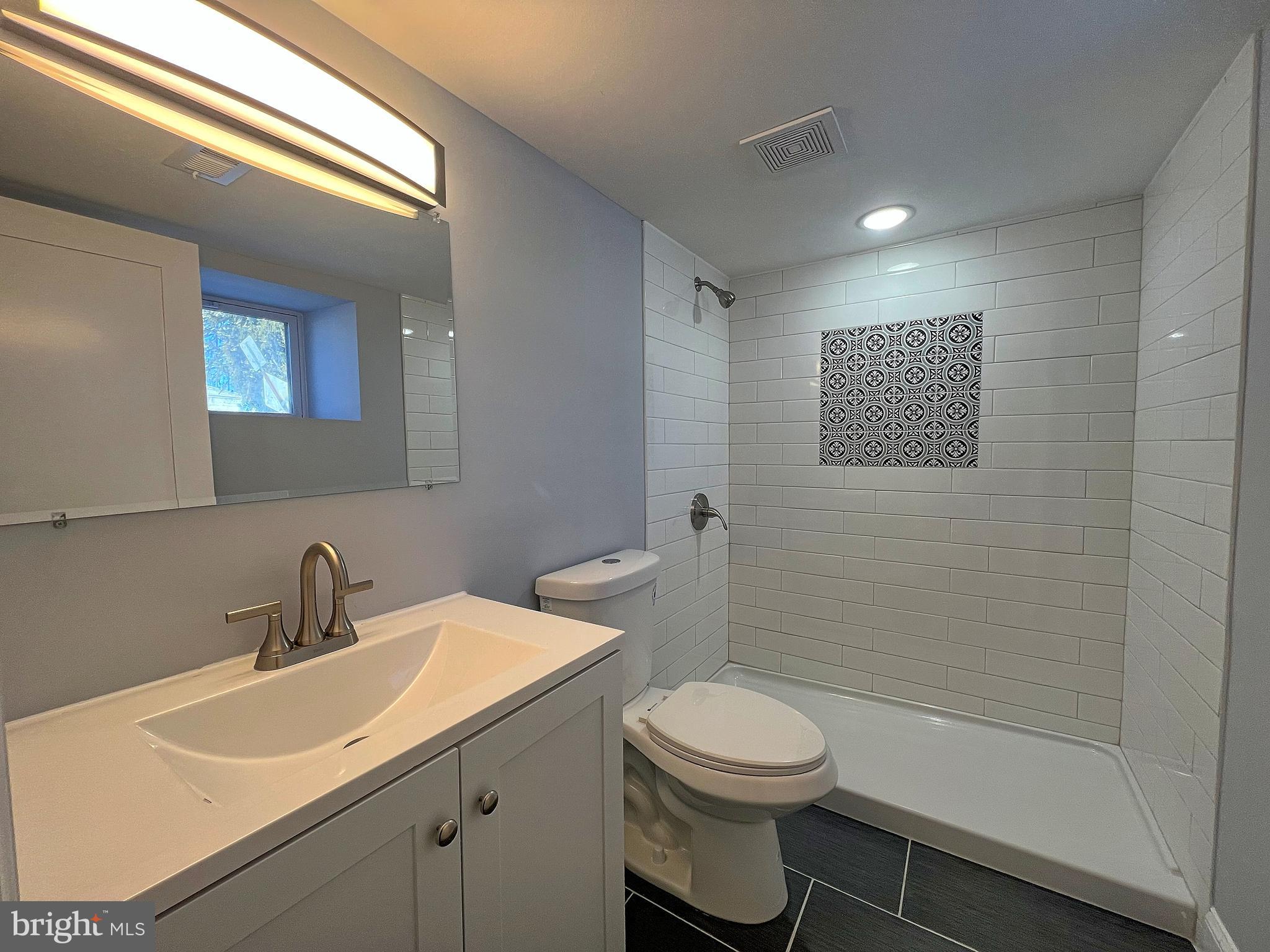 4311 Miami Place Baltimore, MD 21207 - Photo 24 of 26 a bathroom with a toilet sink a mirror and shower