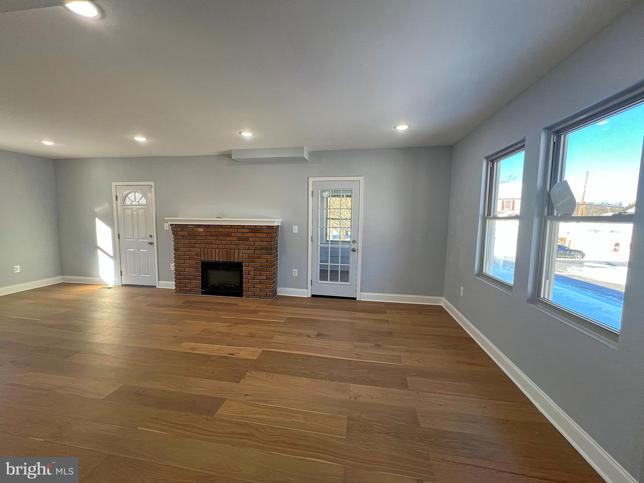 4311 Miami Place Baltimore, MD 21207 - Photo 3 of 26 an empty room with windows and fireplace