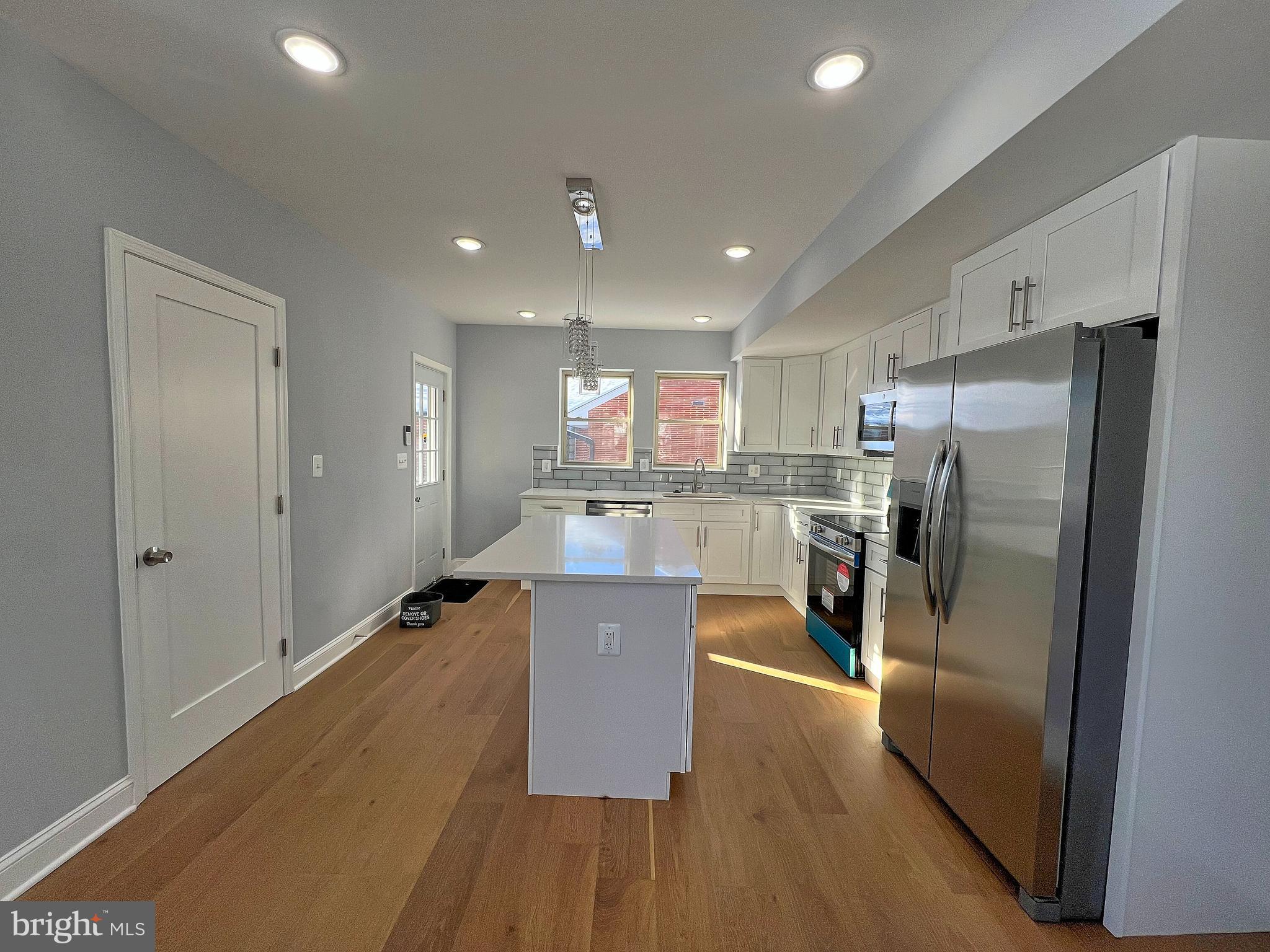 4311 Miami Place Baltimore, MD 21207 - Photo 10 of 26 a kitchen with stainless steel appliances granite countertop a refrigerator a sink a stove and a wooden floors