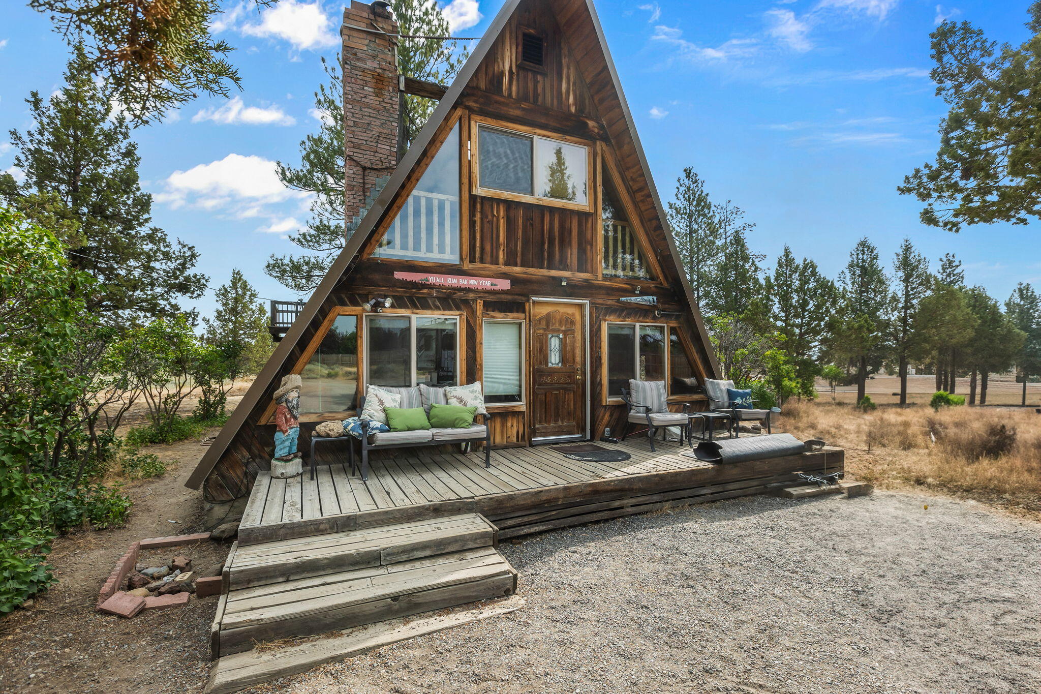 67153 Harrington Loop Road Bend, OR 97703 - Photo 1 of 23 a view of house with yard porch and outdoor seating