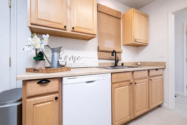 a kitchen with white cabinets and a sink