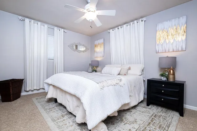 a bedroom with a bed and a window